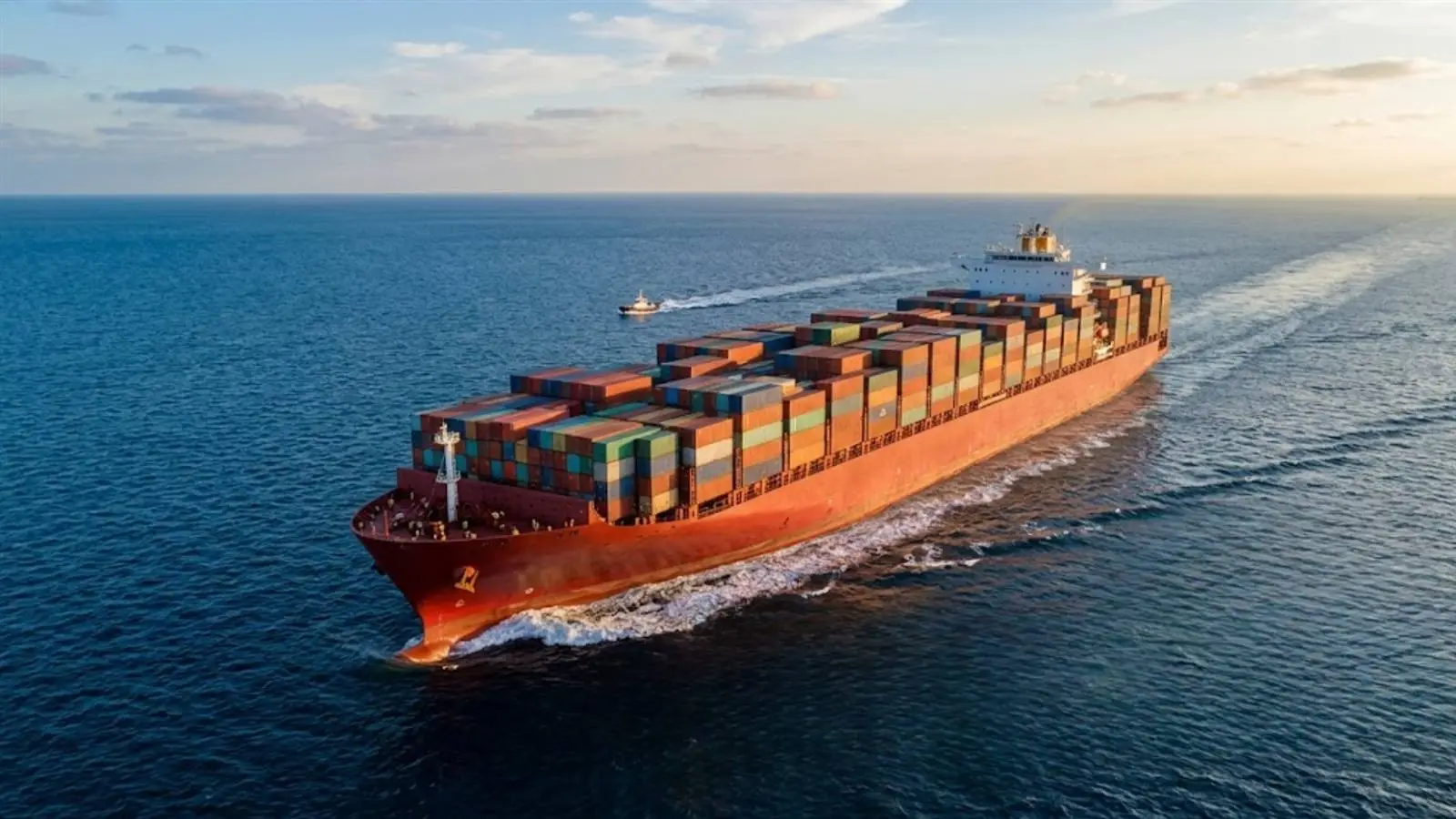 Loaded container vessel under way at dusk